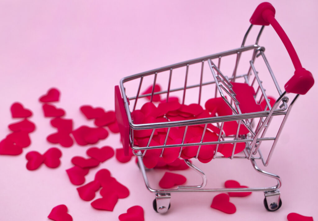 shopping cart filled with red hearts pink background decorative basket with small hearts